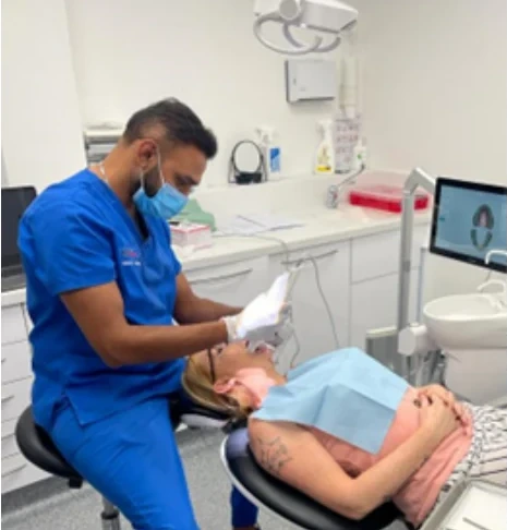 A clinician caring for a patient in an Iconic Smiles surgery.