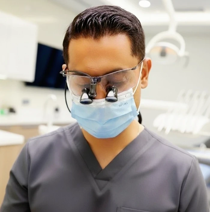 Mayur working with dental magnification.