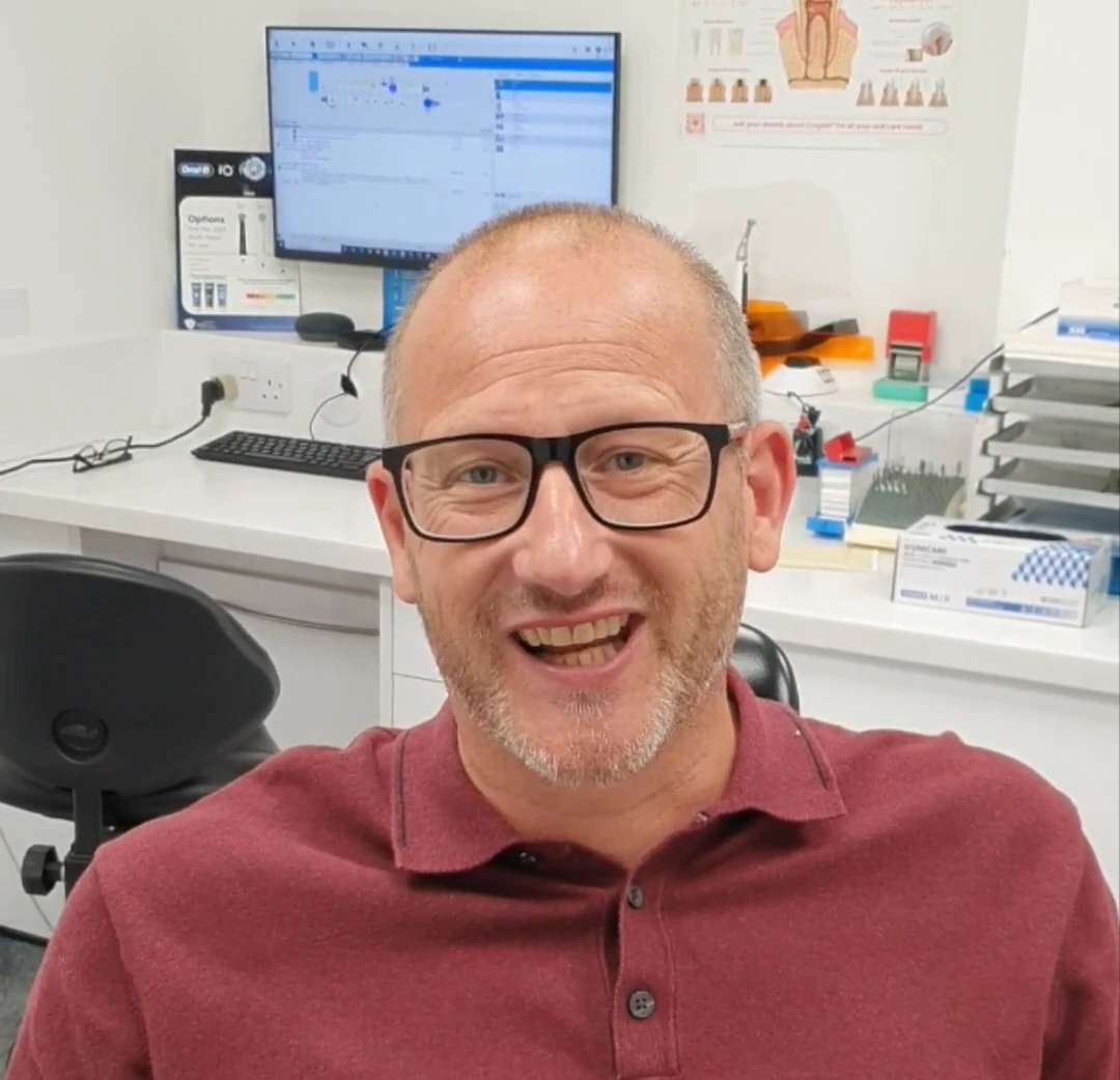 A patient smiling while sharing his Iconic Smiles experience.
