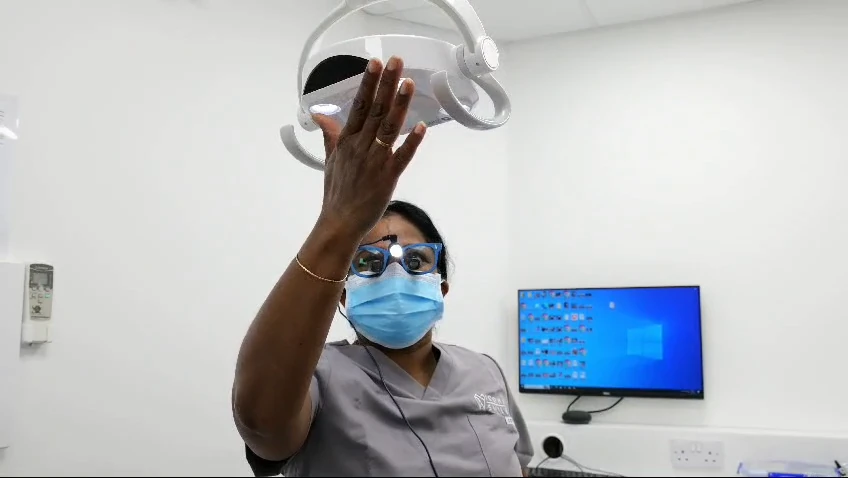 Preparing the treatment light in an Iconic Smiles surgery.
