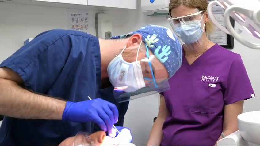 An Iconic Smiles clinician and nurse providing carefully controlled dental care.